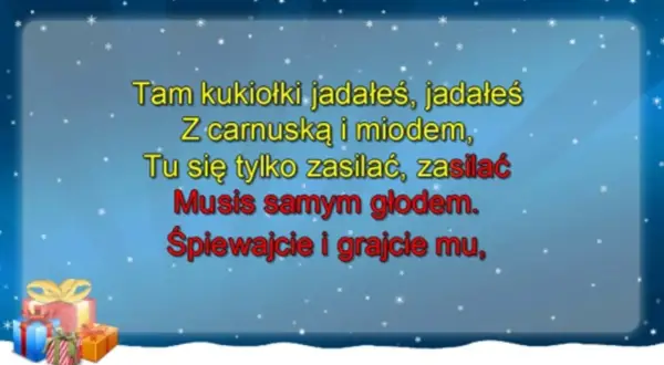 Śnieżna sceneria z prezentami i tekstem piosenki: "Tam kukiołki jadałeś... Śpiewajcie i grajcie mu".